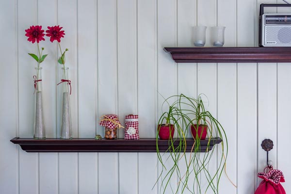 Wooden shelves with flower vases