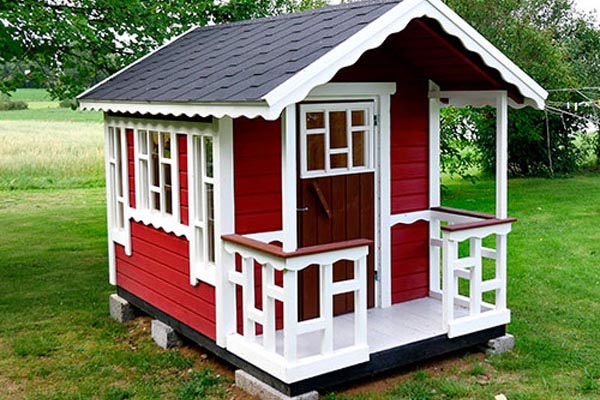 Red wendy house painted with white accents
